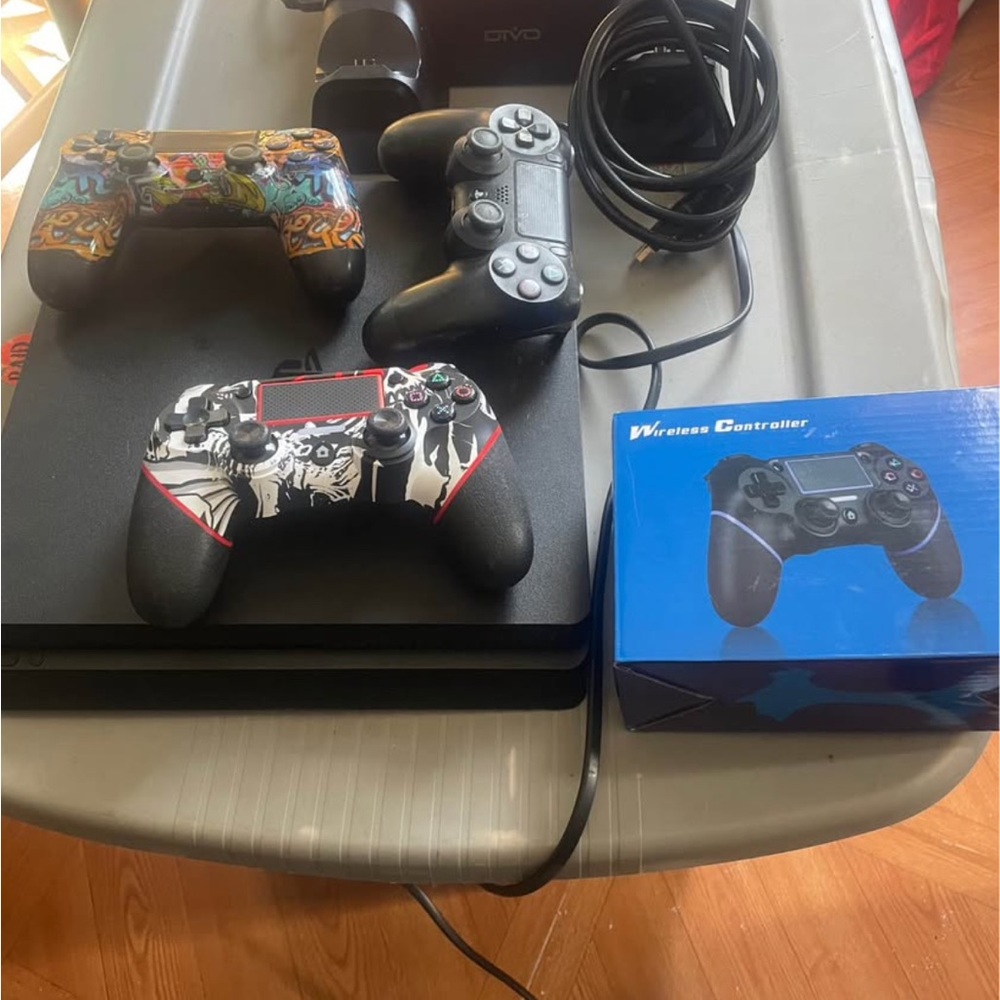 Sony PlayStation Console with Black and Graphic Controllers